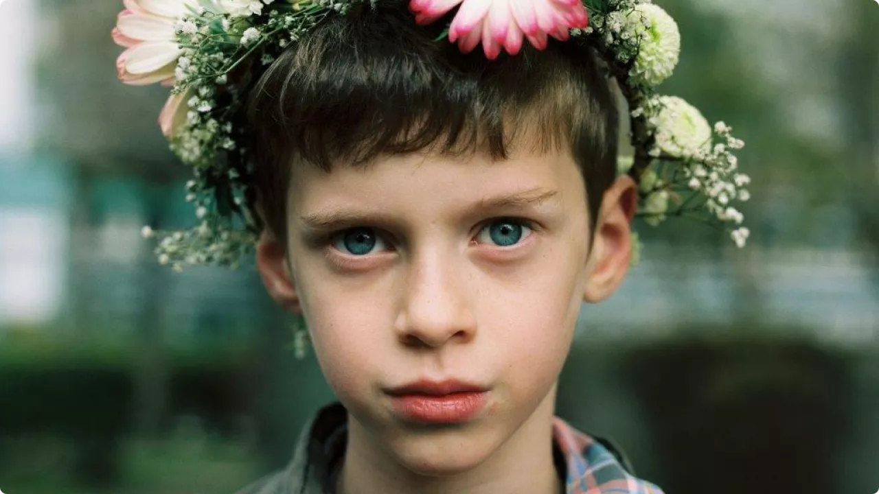 nom de l'œuvre : Sans titre, 2017 (anniversaire) de Tami NOTSANI. Portrait d'un enfant aux yeux bleux, coiffé d'une couronne de fleurs.